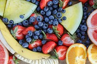 Fresh fruits on a wooden board at a picnic