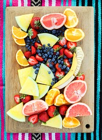 Fresh fruits on a wooden board at a picnic