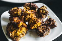 Dry chicken tikka on a white plate