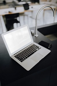 A laptop on a black counter