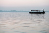 Wooden boat sailing on the River Ganges in Varanasi, India