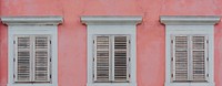 Pink concrete wall with white windows