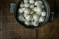 Raw white onions in a pot