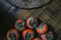 Fresh ripe persimmons on a wooden table