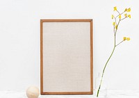 Blank photo frame by a yellow forsythia