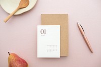 White card mockup on a pastel pink table