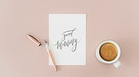 White paper mockup by a coffee cup on a pink table flatlay