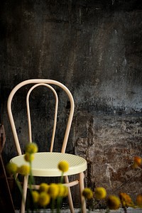 Vintage chair by a cement wall