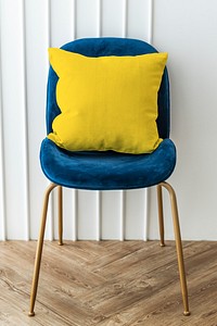 Yellow cushion on a blue velvet chair