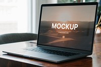 Laptop mockup on a wooden table in a meeting room