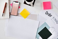 Mobile phone on a desk with a paper mockup