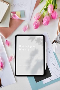 Digital tablet mockup on a table with flowers