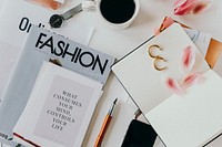Fashion magazine by a notebook
