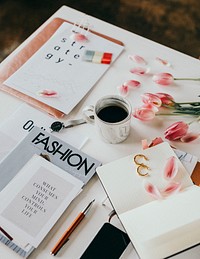 Fashion magazine with coffee and flowers