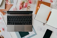 Fresh flowers on a desk with a notebook