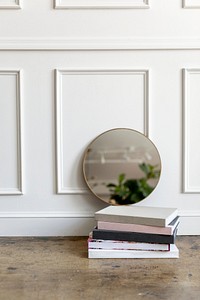Framed mirror by a white wall