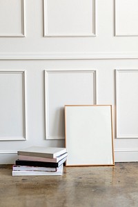 Blank frame by a white wall