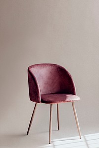 Pink chair by a white wall
