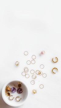 Many earrings on white marble table