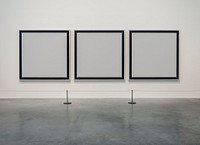 Three empty painting frames in an exhibition