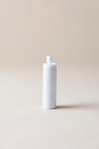 White blank spray bottle on a beige background