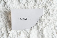 Blank business card mockup on white powder