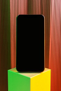 Black smartphone on neon cubic stand