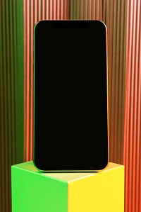 Black smartphone on neon cubic stand
