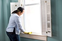 Woman using a damp sponge to clean dust collected on a window sill. Original image sourced from US Government department: Public Health Image Library, <a href="https://www.rawpixel.com/search/cdc?sort=curated&amp;page=1">Centers for Disease Control and Prevention</a>. Under US law this image is copyright free, please credit the government department whenever you can&rdquo;.