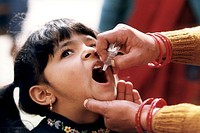 A young Indian girl receiving a dose of oral polio vaccine by a trained healthcare worker. Original image sourced from US Government department: Public Health Image Library, <a href="https://www.rawpixel.com/search/cdc?sort=curated&amp;page=1">Centers for Disease Control and Prevention</a>. Under US law this image is copyright free, please credit the government department whenever you can&rdquo;.
