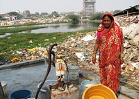 An Indian woman collecting water from one of the town&rsquo;s wells, that happened to be situated adjacent to this community&rsquo;s refuse dump, which had the potential of contaminating this source of potable water.