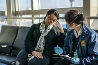 A healthcare worker assessing a sick traveler at the airport. Original image sourced from US Government department: Public Health Image Library, <a href="https://www.rawpixel.com/search/cdc?sort=curated&amp;page=1">Centers for Disease Control and Prevention</a>. Under US law this image is copyright free, please credit the government department whenever you can&rdquo;.