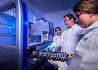 Scientists using automated methods to extract bacterial DNA, for use in whole genome sequencing (WGS).