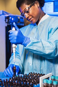 Scientist pipetting samples of bronchoalveolar lavage (BAL) fluid. Original image sourced from US Government department: Public Health Image Library, Centers for Disease Control and Prevention. Under US law this image is copyright free, please credit the government department whenever you can&rdquo;.