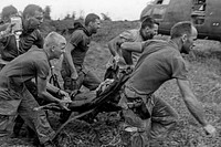 Soldiers carrying out their wounded buddies after a M-33 grenade booby trap was set off in their position (1969). Original image from National Museum of Health and Medicine. Digitally enhanced by rawpixel.