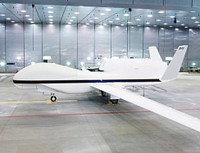 One of NASA&#39;s two Global Hawk unmanned aircraft shows off its new blue-and-white livery shortly after being repainted in the Edwards Air Force Base paint hangar. Original from NASA . Digitally enhanced by rawpixel.