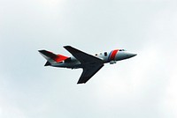 U.S. Coast Guard HU-25 Falcon jet flies overhead during a rescue training exercise, known as Mode VIII, off Florida&#39;s central east coast. Original from NASA. Digitally enhanced by rawpixel.