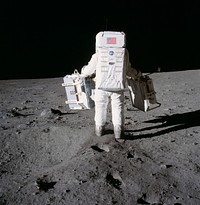 Astronaut Edwin Aldrin prepares to deploy two components of the Early Apollo Scientific Experiments Package (EASEP) on the surface of the Moon during the Apollo 11 extravehicular activity. This photograph was taken by Astronaut Neil A. Armstrong, commander. Original from NASA. Digitally enhanced by rawpixel.