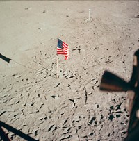 The flag of the United States and the footprints of astronauts Neil A. Armstrong and Edwin E. Aldrin Jr., deployed on the surface of the moon. Original from NASA. Digitally enhanced by rawpixel.