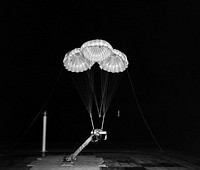 Black and white negative photograph of Apollo 3 Parachute cluster, flown vertically in 40x80 wind tunnel. Original from NASA. Digitally enhanced by rawpixel.