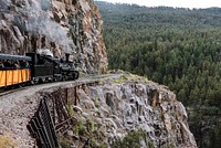 A Durango &amp; Silverton Narrow-Guage Scenic Railroad train, pulled by a vintage steam locomotive, navigates a San Juan Mountains precipice in Las Animas County, Colorado. Original image from <a href="https://www.rawpixel.com/search/carol%20m.%20highsmith?sort=curated&amp;page=1">Carol M. Highsmith</a>&rsquo;s America, Library of Congress collection. Digitally enhanced by rawpixel.