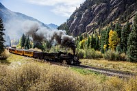 Scenic Railroad train, pulled by a vintage steam locomotive, chugs through the San Juan Mountains in the Colorado county of the same name.