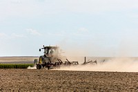 A farmer kicks up dust as he readies the ground for planting near Bristol in Prowers County, Colorado. Original image from Carol M. Highsmith&rsquo;s America, Library of Congress collection. Digitally enhanced by rawpixel.