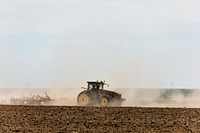 A farmer kicks up dust as he readies the ground for planting near Bristol in Prowers County, Colorado. Original image from Carol M. Highsmith&rsquo;s America, Library of Congress collection. Digitally enhanced by rawpixel.