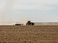 A farmer kicks up dust as he readies the ground for planting near Bristol in Prowers County, Colorado. Original image from <a href="https://www.rawpixel.com/search/carol%20m.%20highsmith?sort=curated&amp;page=1">Carol M. Highsmith</a>&rsquo;s America, Library of Congress collection. Digitally enhanced by rawpixel.