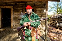 Mountain Man character in front of cabins at the Hickory Ridge Living History Museum in Boone, North Carolina. Original image from Carol M. Highsmith&rsquo;s America, Library of Congress collection. Digitally enhanced by rawpixel.
