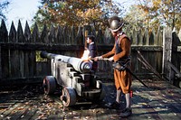 Historic interpreters Chas Ritinski (foreground) and Julie Power fire a cannon from a parapet at the state-sponsored living-history museum in Jamestown Settlement, Virginia. Original image from <a href="https://www.rawpixel.com/search/carol%20m.%20highsmith?sort=curated&amp;page=1">Carol M. Highsmith</a>&rsquo;s America, Library of Congress collection. Digitally enhanced by rawpixel.