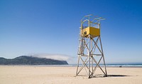Lifeguard tower and a low, passing cloud on the beach of the small, Pacific Ocean town of Seaside, Oregon. Original image from <a href="https://www.rawpixel.com/search/carol%20m.%20highsmith?sort=curated&amp;page=1">Carol M. Highsmith</a>&rsquo;s America, Library of Congress collection. Digitally enhanced by rawpixel.