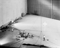 Wide shot of 40x 80 wind tunnel settling chamber with Lockheed XFV-1 model. Project engineer Mark Kelly (not shown). Remote controlled model flown in the settling chamber of the 40x80 wind tunnel. Original from NASA. Digitally enhanced by rawpixel.
