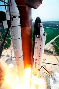 Blasting through the hazy late morning sky, the Space Shuttle Discovery soars from Launch Pad 39A on Aug. 7. Original from NASA . Digitally enhanced by rawpixel.